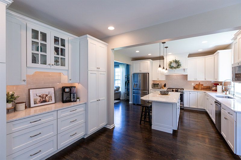 Custom Kitchen Services featuring a bright kitchen with white cabinets and wood floors in Delaware