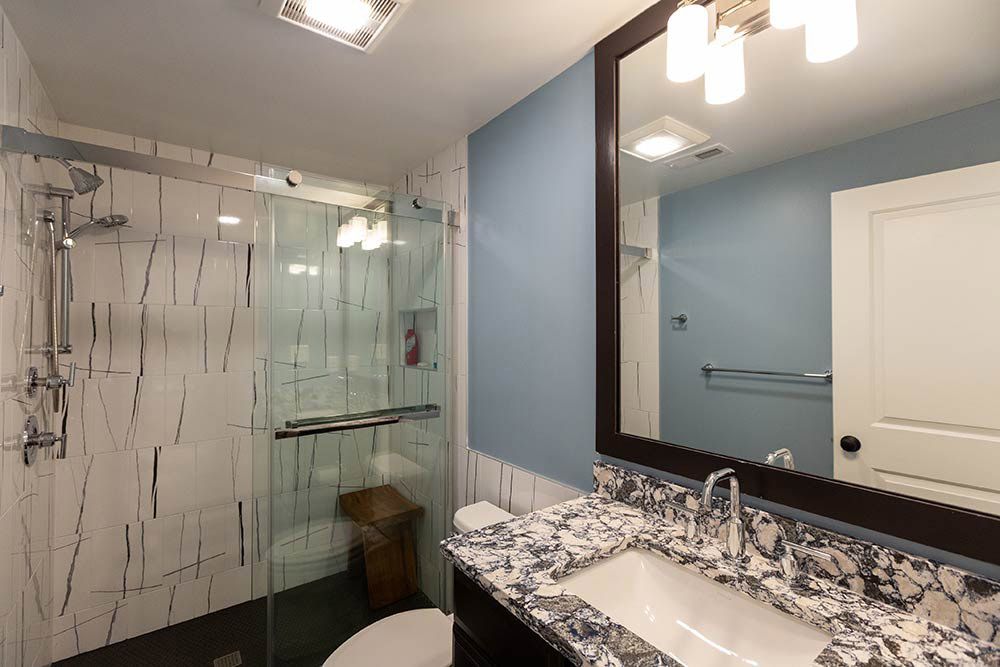 Bathroom featuring a shower, sink and toilet in a clean, modern design in Delaware