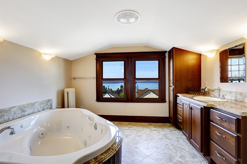 Large bathroom with a tub and window, providing a bright and relaxing space in Newark, DE