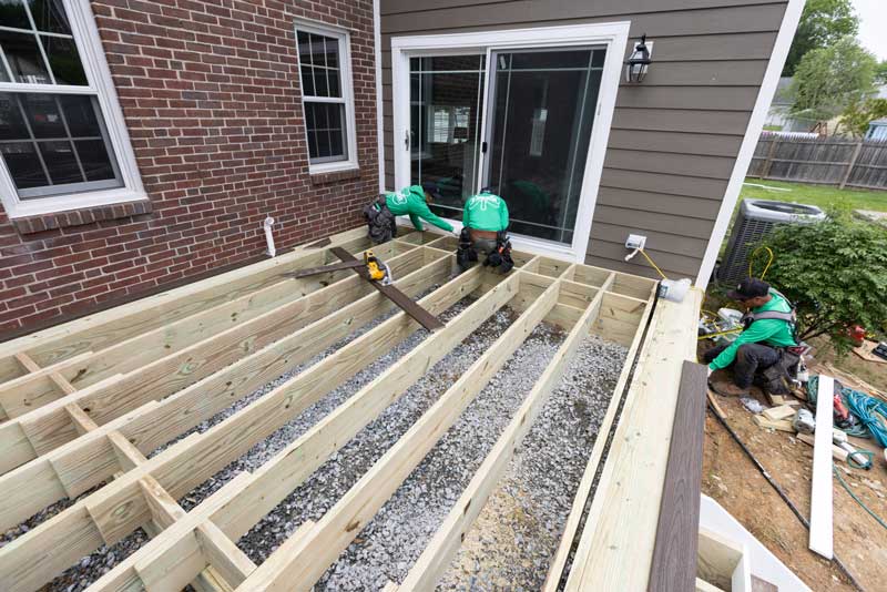 Outdoor living experience featuring a white pergola and chairs on a deck in Newark, DE