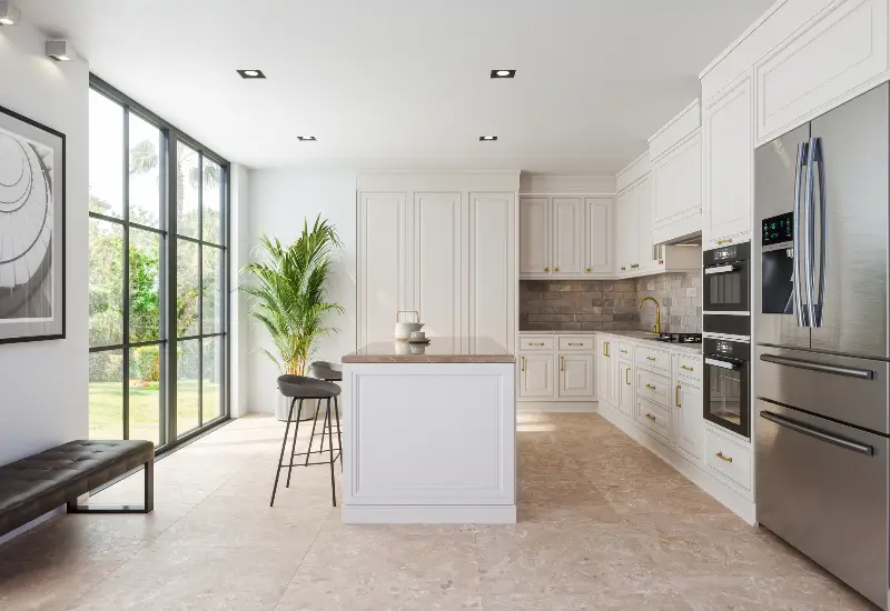 A renovated kitchen with white cabinets and an island