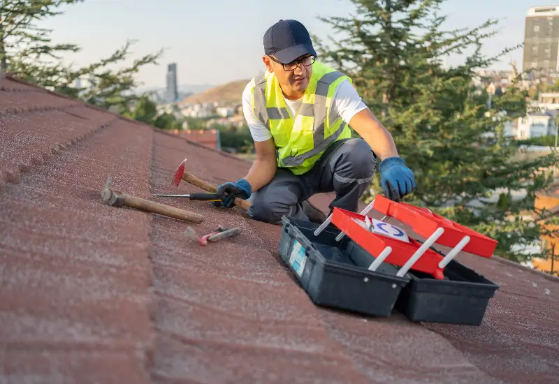 A roofing contractor doing repairs on a residence