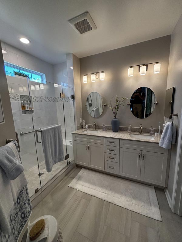 Modern bathroom with double vanity and glass‑enclosed shower