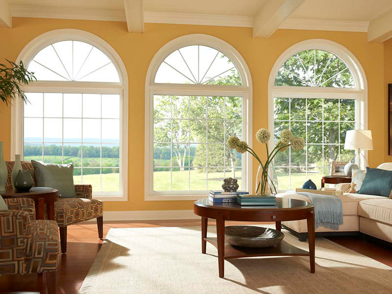 Bright Delaware living room with large arched windows and scenic outdoor views