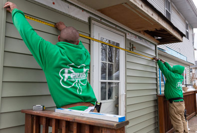 The Ferris Home Improvements workers measuring the house at Newark, De