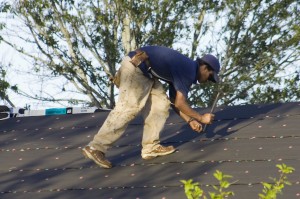 man is repairing house roof