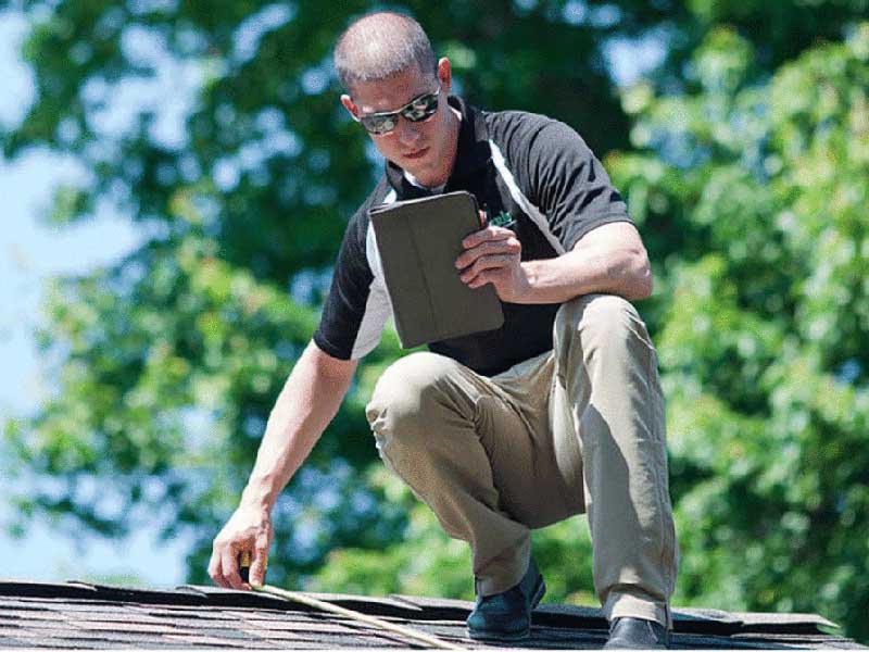 A Man inspecting a roof