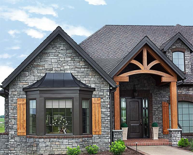 A stone residence with a brick front highlighting window installation in Newark, DE