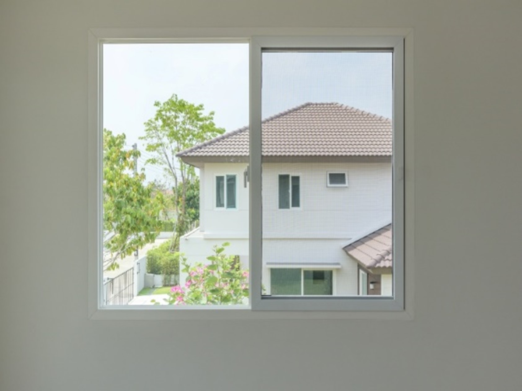 A window with a house seen through it